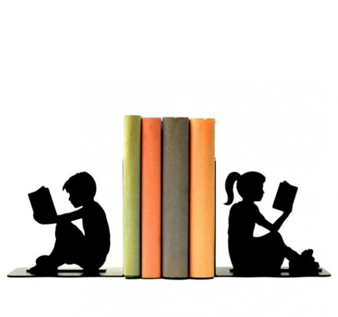Decorative metal book stand with the shape of a child reading a book