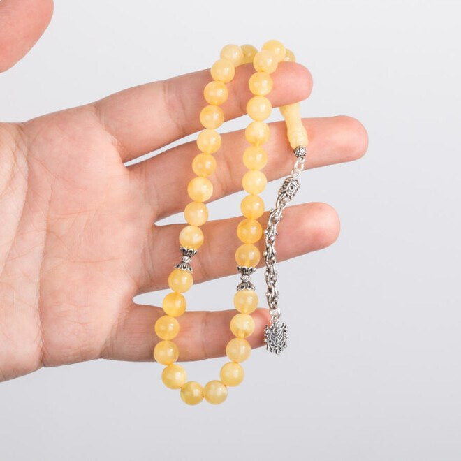 A wrist-sized amber rosary with a tassel having the Ottoman Coat