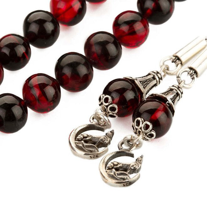 Mixed Red Pressed Amber rosary with two tassels bearing a Gray Wolf symbol