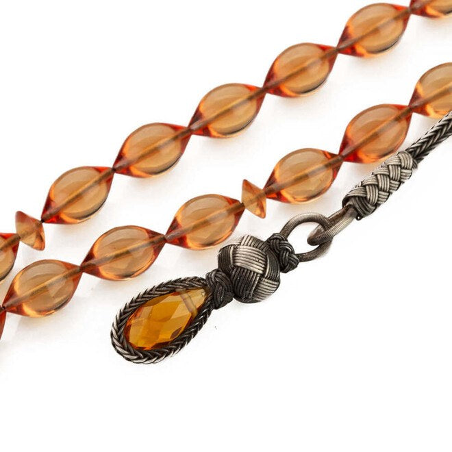 Pressed amber rosary cut using barley wood with a glass- ended tassel