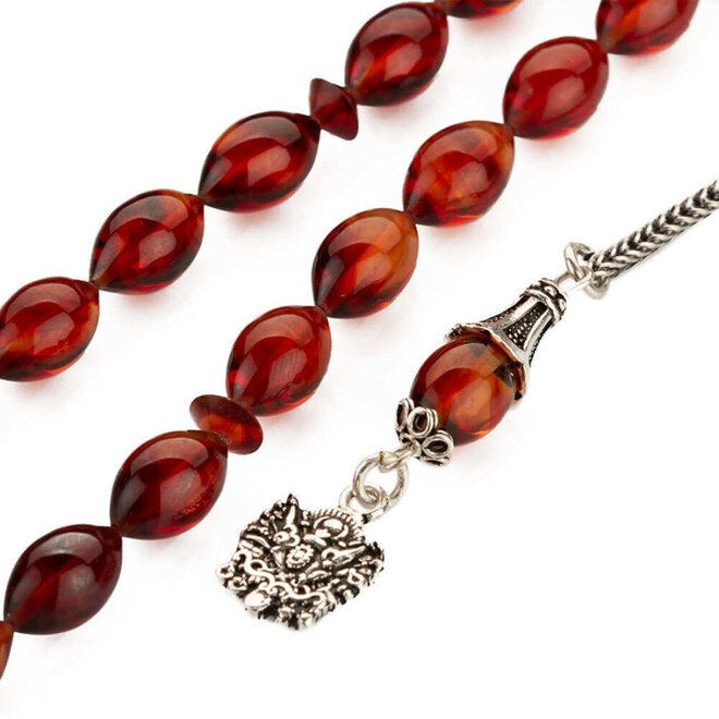 Rosary made of pressed amber with a tassel bearing the symbol of an Ottoman Coat