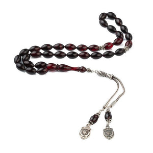 Rosary made of pressed amber with a double and police symbol decorated tassel
