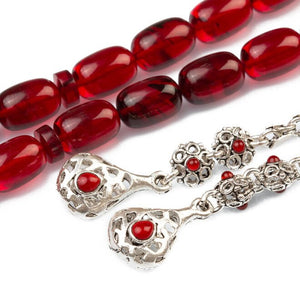 Red rosary made of pressed amber with a silver tassel