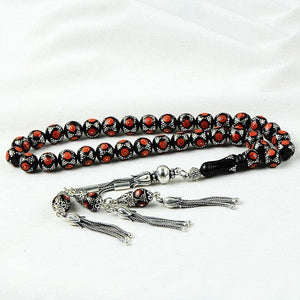 Rosary made of lignite stone embroidered with coral