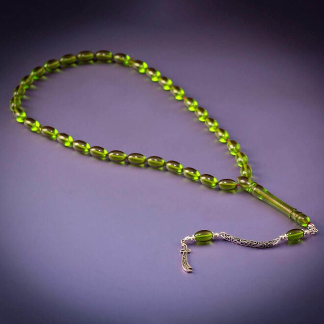 Rosary made of pressed amber with a tassel bearing the zulfiqar sword