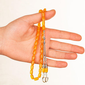 Rosary made of pressed amber with double tassel bearing a moon star symbol
