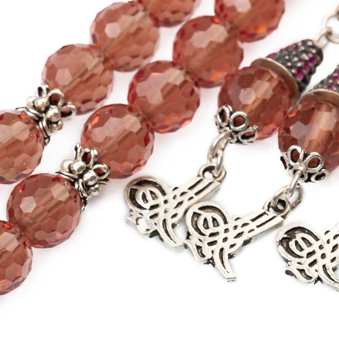 A color-changing sultan stone rosary with a triple tassel bearing the symbol of the tughra