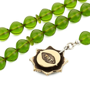 Rosary of pressed amber with a tassel bearing the hoopoe bird symbol
