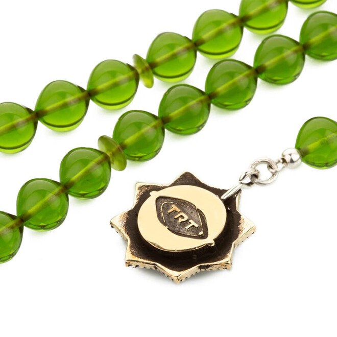 Rosary of pressed amber with a tassel bearing the hoopoe bird symbol