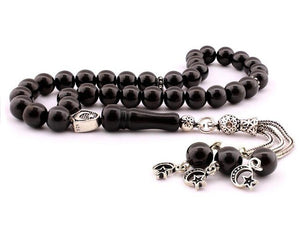 Lignite rosary with a silver tassel bearing the symbols of the moon star