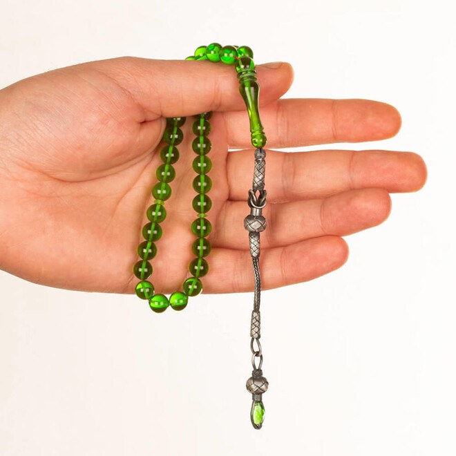 Green rosary of pressed amber with spherical glass beads