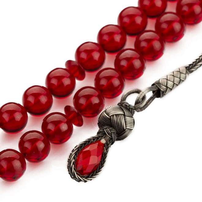 Red Pressed Amber rosary with a tassel carrying a glass piece