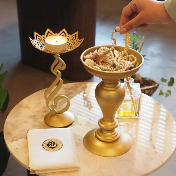 Metal candle holder with My Light written on it in arabic .