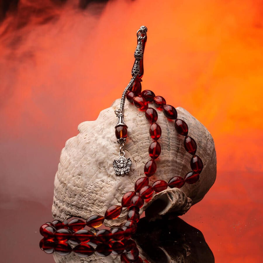 Rosary made of pressed amber with a tassel bearing the symbol of an Ottoman Coat - 1